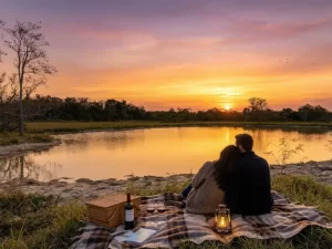 Couple enjoying sunset picnic by lake.